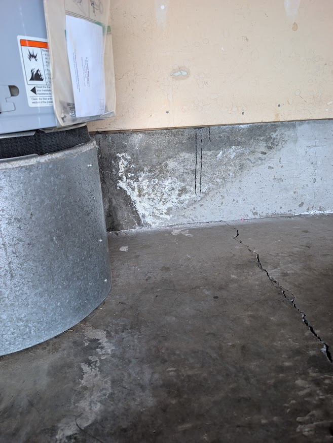 Garage wall on Alabama Hill in Bellingham with white water staining on the concrete from an old flood